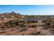 Aerial view of property with a house, detached garage, and desert landscape at 5089 E 26Th Ave, Apache Junction, AZ 85119