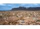 Aerial view of a home in a desert setting with mountains in the background at 5089 E 26Th Ave, Apache Junction, AZ 85119