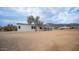 House exterior with covered porch and desert landscape at 5089 E 26Th Ave, Apache Junction, AZ 85119