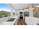 Modern kitchen with white cabinets, stainless steel appliances, and expansive windows at 5089 E 26Th Ave, Apache Junction, AZ 85119