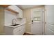 Laundry room with white cabinets and a door to outside at 5089 E 26Th Ave, Apache Junction, AZ 85119