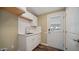 Laundry room with white cabinets and a door to outside at 5089 E 26Th Ave, Apache Junction, AZ 85119