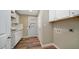 Laundry room with white cabinets and a door to outside at 5089 E 26Th Ave, Apache Junction, AZ 85119