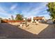 Sunny backyard, gravel landscaping, and wooden fence at 5519 W Elgin St, Chandler, AZ 85226