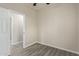 Simple bedroom with ceiling fan and grey wood-look flooring at 562 N Lewis --, Mesa, AZ 85201