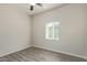 Simple bedroom with ceiling fan and grey wood-look flooring at 562 N Lewis --, Mesa, AZ 85201