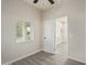 Bright bedroom with ceiling fan, window blinds, and grey wood-look flooring at 562 N Lewis --, Mesa, AZ 85201