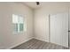 Bedroom with ceiling fan, window blinds, and grey wood-look flooring at 562 N Lewis --, Mesa, AZ 85201