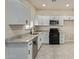 Modern kitchen with white cabinets, granite counters, and stainless steel appliances at 562 N Lewis --, Mesa, AZ 85201