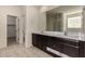 Bathroom with double sinks, large mirror, and separate shower at 5656 N 109Th Ave, Phoenix, AZ 85037