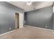 Simple bedroom with gray walls, carpet, and a closet at 5656 N 109Th Ave, Phoenix, AZ 85037