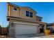 Two-story house with beige exterior, two-car garage, and landscaping at 5656 N 109Th Ave, Phoenix, AZ 85037