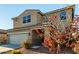 Two-story house with beige exterior, two-car garage, and landscaping at 5656 N 109Th Ave, Phoenix, AZ 85037