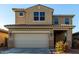 Two-story house with beige exterior, two-car garage, and landscaping at 5656 N 109Th Ave, Phoenix, AZ 85037