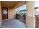 Covered front porch with a brown door and small landscaping at 5656 N 109Th Ave, Phoenix, AZ 85037