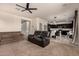 Open Gathering room with a view of kitchen and black seating at 5656 N 109Th Ave, Phoenix, AZ 85037