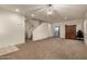 Spacious living area with stairs, carpeting, and a built-in cabinet at 5656 N 109Th Ave, Phoenix, AZ 85037