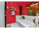 Bathroom with a bathtub, red walls, and Asian decor at 5777 N 78Th Pl, Scottsdale, AZ 85250