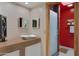 Modern bathroom with a white vessel sink and red walls at 5777 N 78Th Pl, Scottsdale, AZ 85250