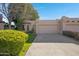 Tan stucco house with a two-car garage and nicely landscaped front yard at 5777 N 78Th Pl, Scottsdale, AZ 85250