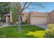 Spanish style home with a lush green lawn and mature trees at 5777 N 78Th Pl, Scottsdale, AZ 85250