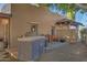 Outdoor patio with built-in grill and small dining area at 5777 N 78Th Pl, Scottsdale, AZ 85250