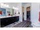 Elegant bathroom with double vanity, walk-in closet, and grey wood-look flooring at 605 N Star Ct, Apache Junction, AZ 85119