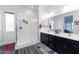 Bright bathroom with walk-in shower, double vanity, and grey wood-look flooring at 605 N Star Ct, Apache Junction, AZ 85119