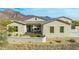 Exterior of house showcasing a modern design and mountain backdrop at 605 N Star Ct, Apache Junction, AZ 85119