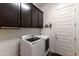 Laundry room with washer, dryer, and storage cabinets at 605 N Star Ct, Apache Junction, AZ 85119