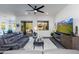 Spacious living room featuring gray couches and a large TV at 605 N Star Ct, Apache Junction, AZ 85119