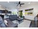 Open living area with gray couches, coffee table, and view of kitchen at 605 N Star Ct, Apache Junction, AZ 85119