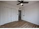 Bedroom with wood-look flooring, ceiling fan and double door closet at 619 N Norfolk --, Mesa, AZ 85205