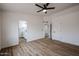 Bedroom with wood-look flooring, ceiling fan and access to bathroom at 619 N Norfolk --, Mesa, AZ 85205