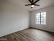 Bright bedroom with wood-look floors, ceiling fan, and large window at 619 N Norfolk --, Mesa, AZ 85205