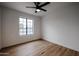 Bedroom with wood-look flooring, ceiling fan and access to bathroom at 619 N Norfolk --, Mesa, AZ 85205