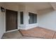 Inviting front entry with a brown door and brick tile flooring at 619 N Norfolk --, Mesa, AZ 85205