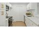 Bright white kitchen featuring updated cabinets, quartz countertops, and stainless steel appliances at 623 W Guadalupe Rd # 223, Mesa, AZ 85210