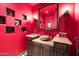 Red bathroom with a vessel sink and decorative shelving at 6601 E Valley Vista Ln, Paradise Valley, AZ 85253