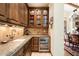 Well-equipped butler's pantry with granite countertops and wine cooler at 6601 E Valley Vista Ln, Paradise Valley, AZ 85253