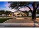 Elegant home exterior at dusk, showcasing architectural details and landscaping at 6601 E Valley Vista Ln, Paradise Valley, AZ 85253