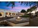 Outdoor fire pit area with brick seating wall, perfect for evening relaxation at 6601 E Valley Vista Ln, Paradise Valley, AZ 85253