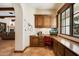 Home office with built-in wood desk and cabinets at 6601 E Valley Vista Ln, Paradise Valley, AZ 85253