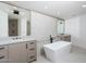 Spa-like bathroom with a freestanding tub and dual sinks at 7175 E Camelback Rd # 601, Scottsdale, AZ 85251