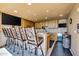 Community bar area with wood cabinets, granite countertop, and barstools at 7175 E Camelback Rd # 601, Scottsdale, AZ 85251