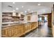 Community kitchen with brick wall, stainless steel shelving, and wooden cabinets at 7175 E Camelback Rd # 601, Scottsdale, AZ 85251