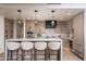 Elegant kitchen with bar seating, modern cabinets, stainless steel appliances, and a built-in wine fridge at 7175 E Camelback Rd # 601, Scottsdale, AZ 85251