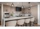 Modern kitchen with a large quartz island, custom cabinets, black hood, and stainless steel appliances at 7175 E Camelback Rd # 601, Scottsdale, AZ 85251