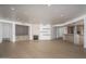 Spacious living room with hardwood floors, fireplace, and built-in shelving at 7175 E Camelback Rd # 601, Scottsdale, AZ 85251