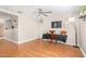 Bright bedroom with ceiling fan, wood floors, and a desk area at 7244 S Sunrise Way, Buckeye, AZ 85326